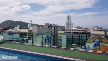 A girl with red hair is sunbathing without a bottom by the pool