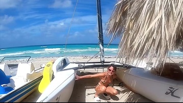 There's a cute chick on the beach getting fucked by a man.